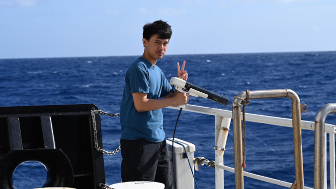student aboard research vessel