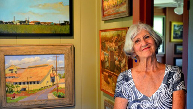 woman standing next to paintings